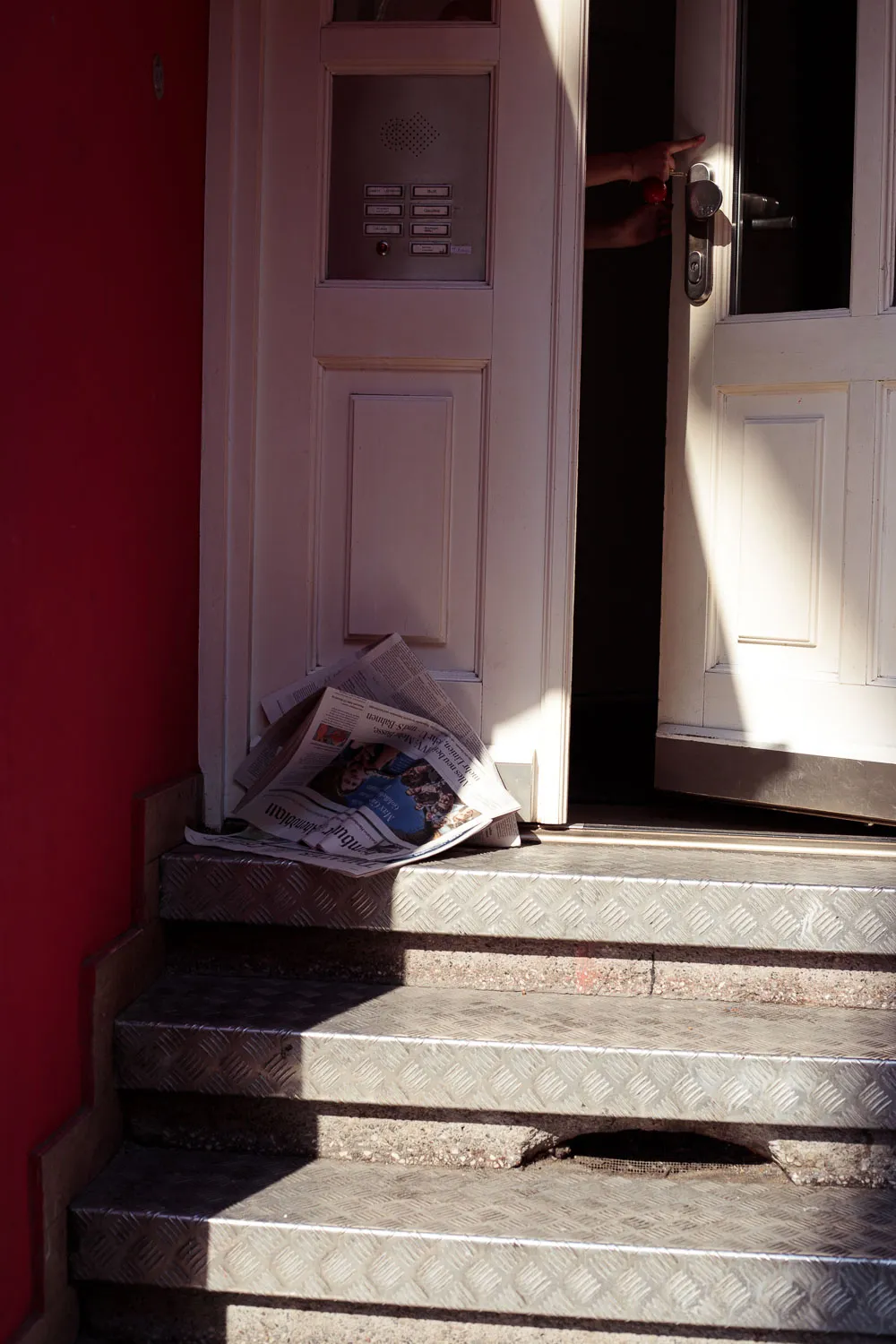 Door opening, newspaper at the door