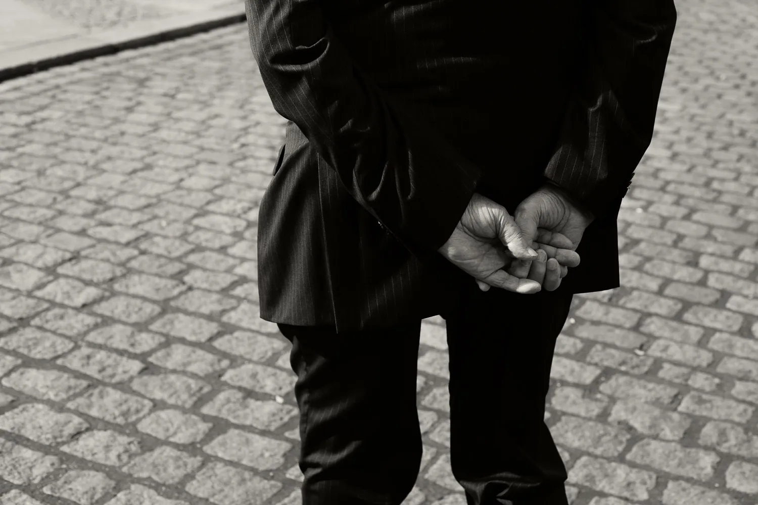 Old man hands and paving stone